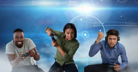 People playing with computer game controllers with blue technology background Stock Photos