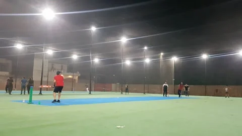 People playing cricket in cage covered with net at night. Stock Footage 346105021