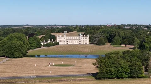 People playing cricket in a field in front of a castle Stock Footage 342751355
