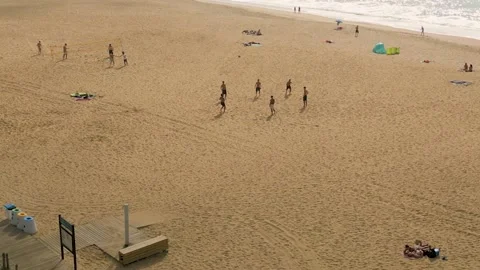 People playing footbal on the beach Stock Footage 219725593