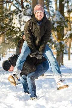 People playing jumping over another person in wintertime Stock Photos