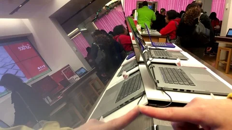 People playing new computer and tapping on screen at Microsoft store Stock Footage 70955390