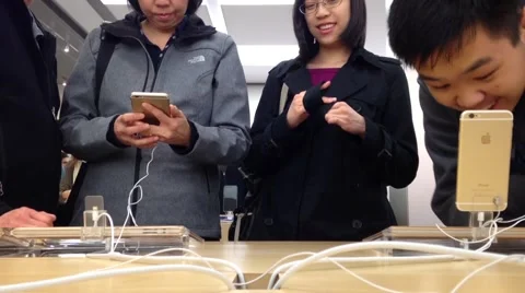 People playing new iphone inside apple store Stock Footage 43099232