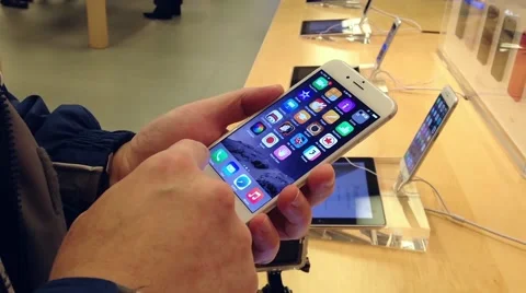 People playing new iphone inside apple store Stock Footage 44324244