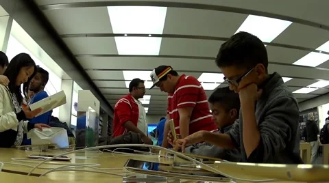 People playing new iphone inside Apple store Stock Footage 47298472