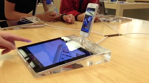 People playing new iphone inside Apple store Stock Footage 54685362