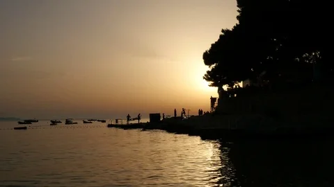 People playing on the pier during sunset Stock-Footage 78908180