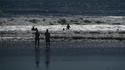 People playing in surf Stock Footage 126669555