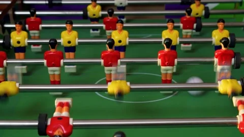 People playing table soccer with cute plastic figures red and yellow Stock Footage 170391278