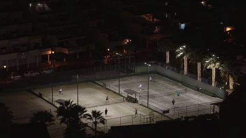 People Playing Tennis in Evening Stock Footage 121856853