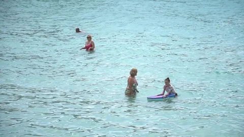 People playing in the water Stock Footage 128348045