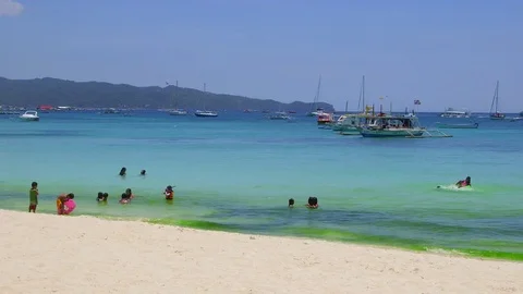 PEOPLE PLAYING WHITE BEACH BORACAY PHILIPPINES Stock Footage