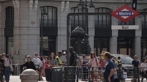 People on a Plaza de Sol, background symbol of Madrid, Bear With Strawberry Tree Stock Footage 76624003