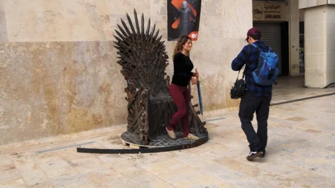 People posing on the game of thrones chair in Valletta, Malta Stock Footage 109562073