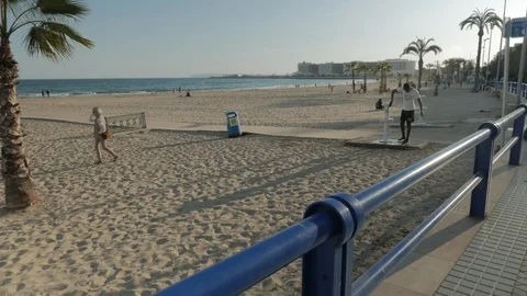 People on Postiguet Beach at sunset Stock Footage 104669990