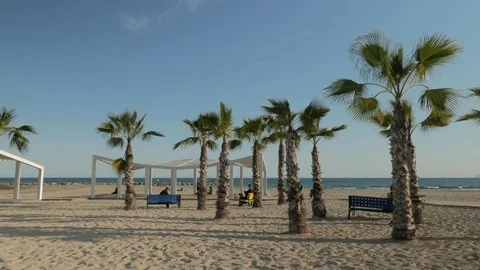 People on Postiguet Beach at sunset Stock Footage 104669993