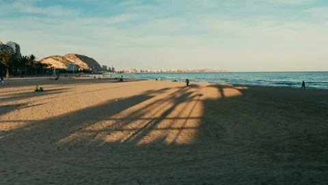 People on Postiguet Beach at sunset Stock Footage 104669998
