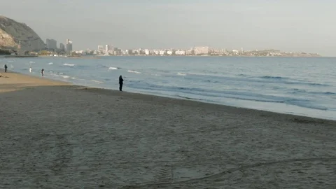 People on Postiguet Beach at sunset Stock Footage 104670000