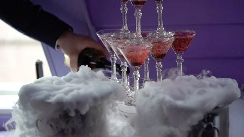 People pouring wine to pyramid of glasses with champagne Stock Footage 93962553
