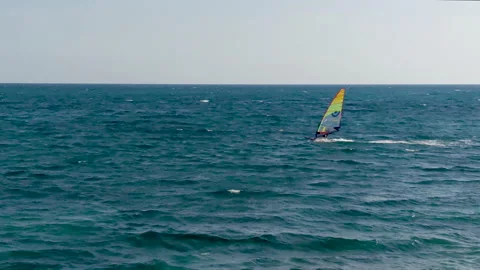 People practice wind surfing in Liguria Stock Footage 132587804