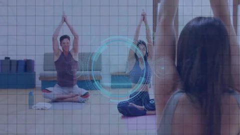 People practicing yoga in studio with digital interface animation overlay Stock Footage 304161005