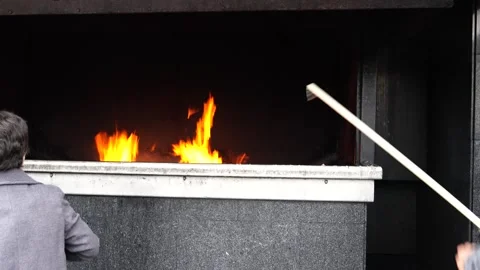 People pray by throwing large candles into the burning fire. Stock Footage 307209871