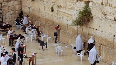 People pray at the Western Wall in Jerusalem Stock Footage 77127616