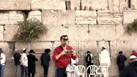 People praying below at the Western Wall (Wailing Wall) in the morning. Jerusale Stock Footage 85404745