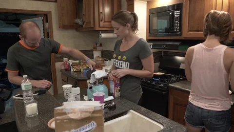 People Prepare Breakfast in 5th Wheel Toy Hauler Stock Footage 80617808