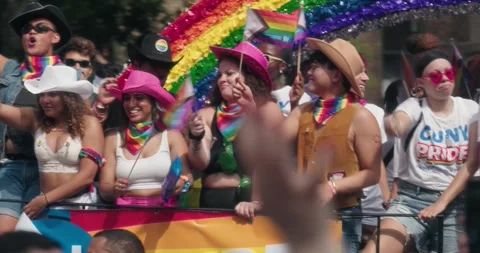 People on pride march train in nyc with rainbow flags 스톡 동영상 247450679