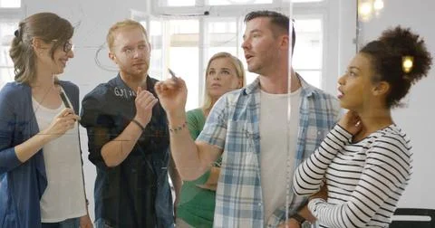 People in process of working on plan View through glass of young diverse p... Foto stock