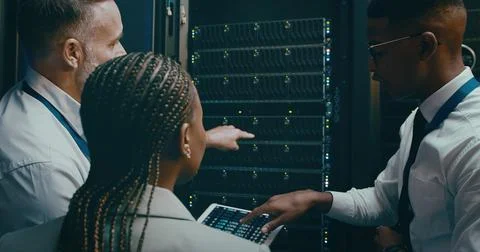 People, programming and tablet in server room, teamwork and engineering with Stock Photos