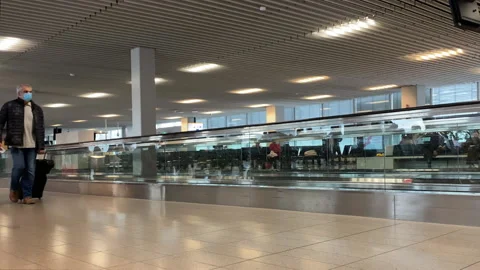 People in protective masks walking down the airport corridor to flight. 스톡 동영상 165336224