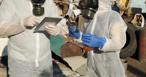 People in protective suits arrived at dump, sample of infectious substances Stock Footage 119049775