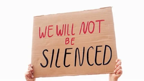People protest for change holding "We will not be silenced" banner on the road  Stock Footage 239784697