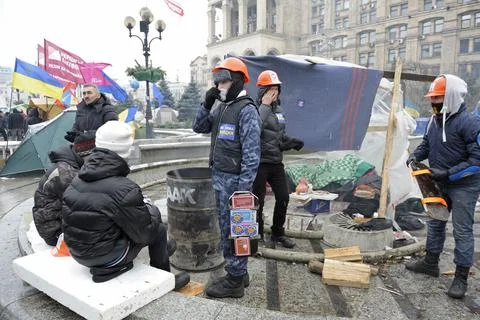 People protesters warming themself on fire in the tent city on Majdan Nezalez Stock Photos