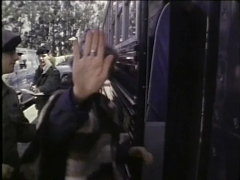 People protesting the MX Missile are arrested and led across a field by police Stock Footage 79463940