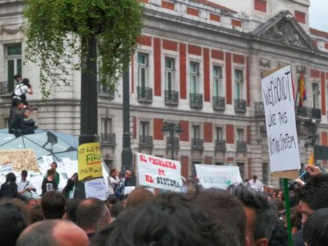 People protesting with placards at Sol station Stock Photos