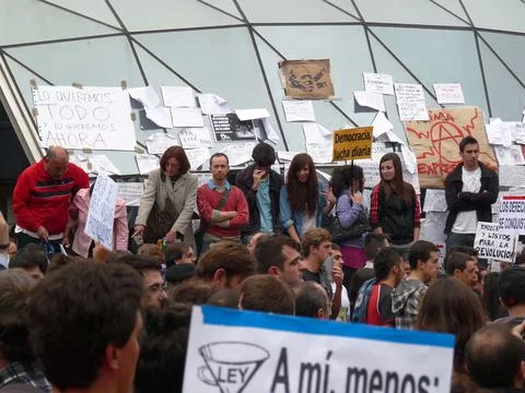 People protesting with placards at Sol station Stock Photos