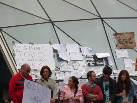 People protesting with placards at Sol station Stock Photos