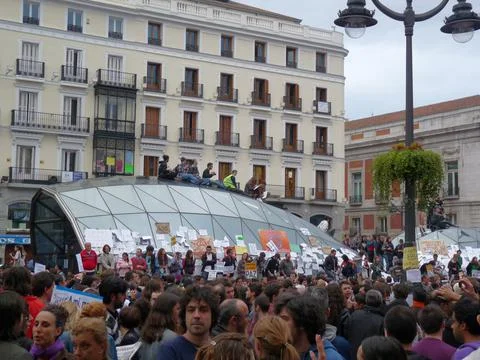 People protesting with placards at Sol station Stock Photos