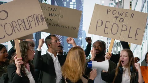 People protesting together during a strike and public march against corruption Stock Footage 326561089