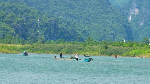 People pull algae with stick from river bottom Stock Footage 100420275