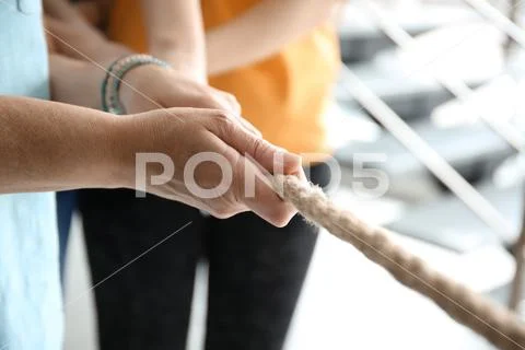 People pulling rope together, closeup of hands. Unity concept ~ Hi Res  #232320803
