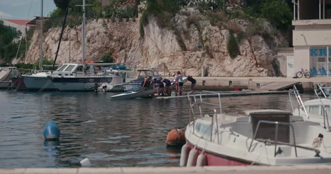 People Pulling Small Boat From the Water at Marina 스톡 동영상 336928194