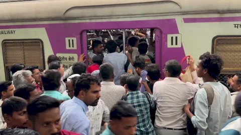 People pushing to board a packed public train during their commute in India Stock Footage 341455701