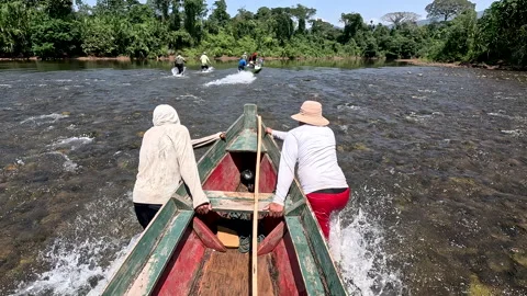 People Pushing a Boat Through Shallow Rapids on Jungle River in Bolivian Amazon Stock Footage 341877856