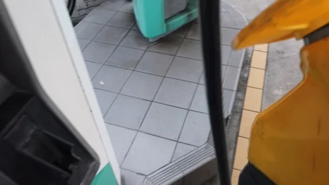 People put back the gas pump nozzle after filling the petrol fuel Stock Footage 106671667