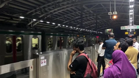 People queue to commute at Dhaka metro rail for train to arrive on crowded Stock Footage 344152028