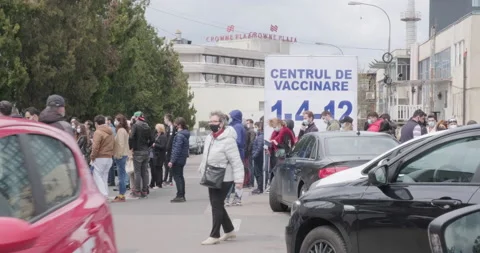 People queue for coronavirus Covid-19 vaccine, in Bucharest, Romania. Stock Footage 153087953